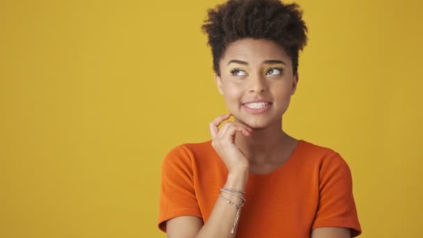 Pensive Smiling Attractive African Woman Thinking Something Looking Yellow Background — Stock Video