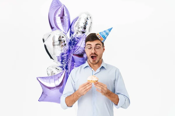 Photo Excited Caucasian Man Party Cone Holding Cake Candle Isolated — Stock Photo, Image