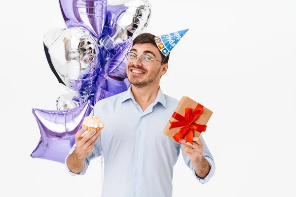 照片上 兴奋的高加索男人在派对上拿着蛋糕 蜡烛和礼品盒与白色背景隔离在一起 — 图库照片