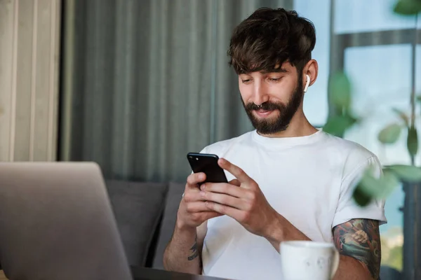 Handsome Smiling Young Bearded Man Working Laptop Computer While Sitting — Stock Photo, Image