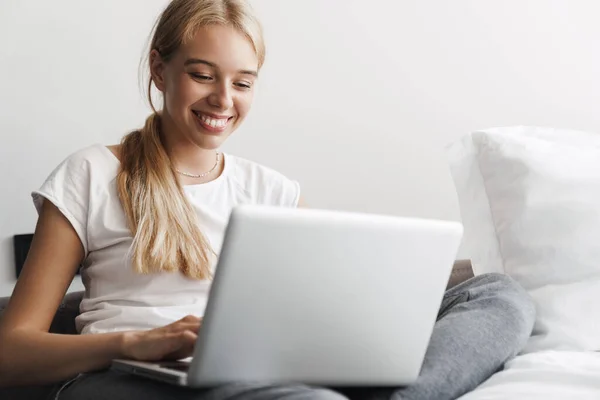 Foto Jovem Mulher Alegre Sorrindo Trabalhando Com Laptop Enquanto Senta — Fotografia de Stock