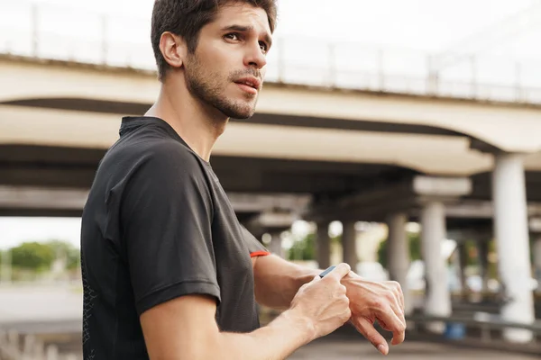 Obrázek Sportovního Mladého Sportovce Pomocí Smartwatch Při Práci Ulici Města — Stock fotografie