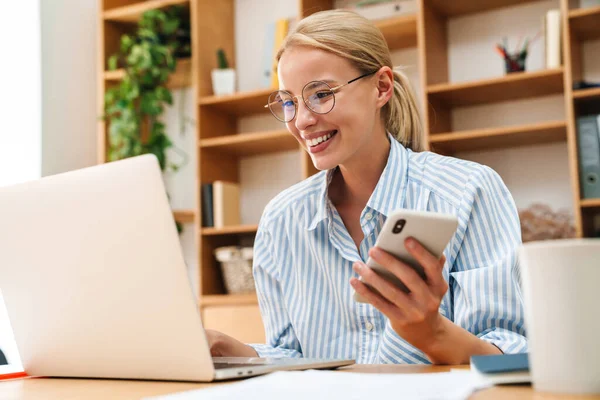 Image Smiling Young Businesswoman Using Cellphone While Working Laptop Table — Stock Photo, Image