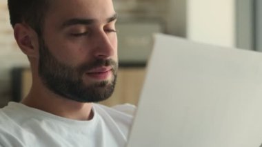 Genç yakışıklı, elinde belgelerle evde oturan ciddi bir adamı strese soktu.