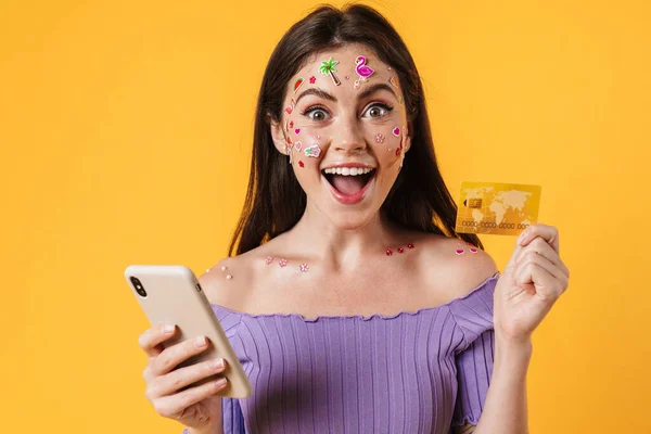 Yüzünde Çıkartmalar Olan Cep Telefonu Kredi Kartı Tutan Mutlu Genç — Stok fotoğraf