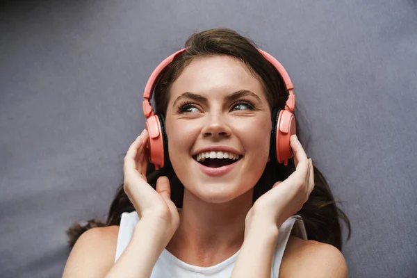 Image Beautiful Joyful Woman Smiling Using Wireless Headphones While Lying — Stock Photo, Image