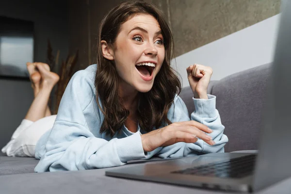 Kép Izgatott Hogy Győztes Gesztus Dolgozik Laptop Miközben Fekszik Kanapén — Stock Fotó