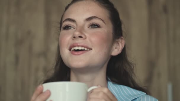 Uma Mulher Sorrindo Está Bebendo Uma Xícara Chá Enquanto Está — Vídeo de Stock