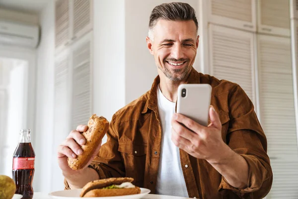 Image Grey Haired Joyful Man Smiling Using Smartphone While Have — Stock Photo, Image