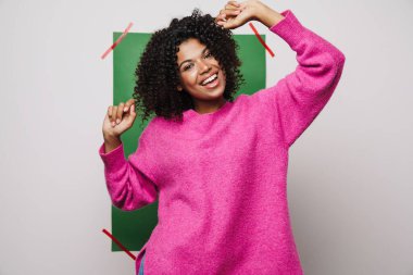 Komik Afrikalı Amerikalı kadın görüntüsü gülümseyen ve dans eden arka planda çok renkli.