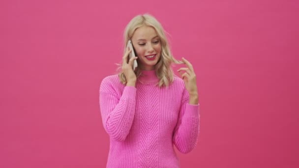 Beautiful Blonde Woman Pink Sweater Talking Her Smartphone Standing Isolated — Stock Video