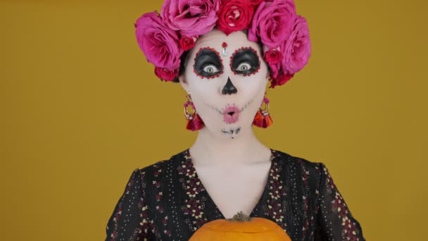 Веселая Женщина Костюме Карнавала Показывает Тыкву Хэллоуина Стоящую Изолированно Жёлтом — стоковое видео
