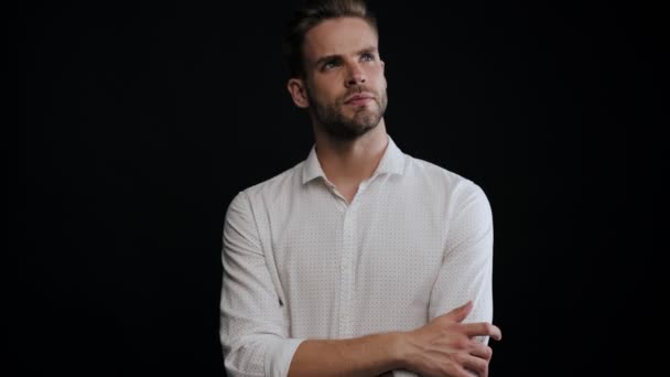 Serious Young Man Thinking Something Standing Isolated Black Background — Stock Video