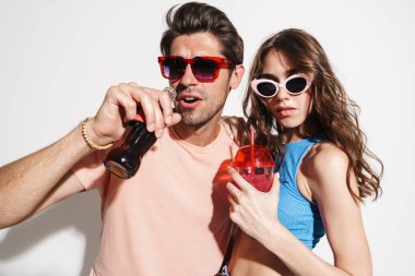 Beyaz arka planda izole edilmiş içecekler içerken dans eden güzel bir çiftin görüntüsü