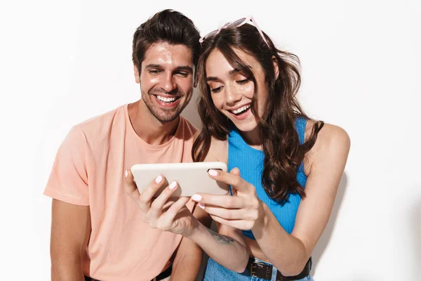 Image Attractive Joyful Couple Laughing While Using Cellphone Isolated White — Stock Photo, Image