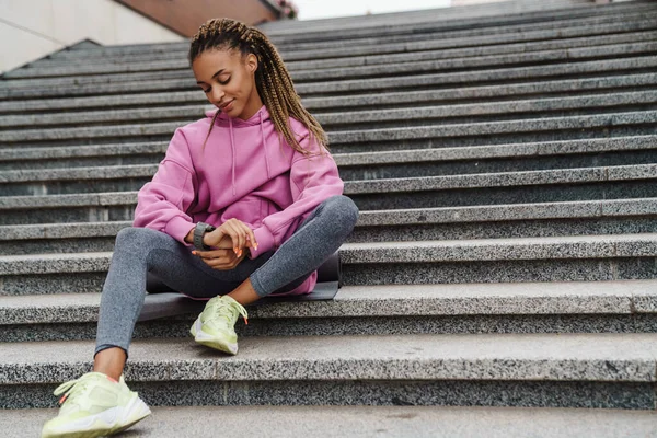 Young Smilling Fit Woman Checking Smart Watch While Sitting Stairs — Stock Photo, Image