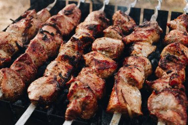 Barbeküde ızgara yapılan et şişleri yakın plan.