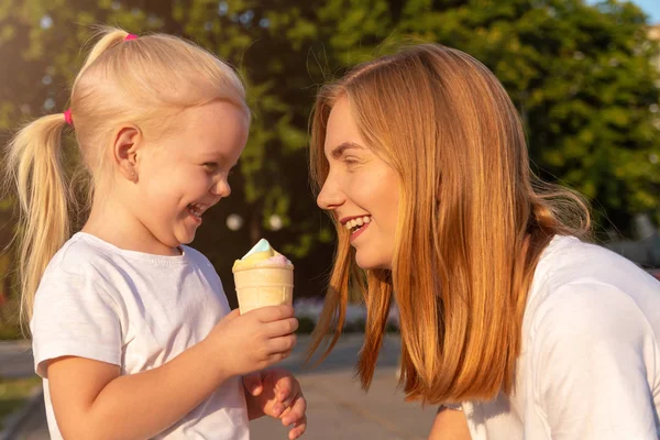 Giovane madre e figlia mangiano un gelato . — Foto Stock