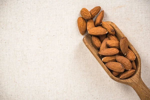 Almond Seeds Wooden Spoon Superfood Copy Space Kitchen Cloth Spotlight — Stock Photo, Image