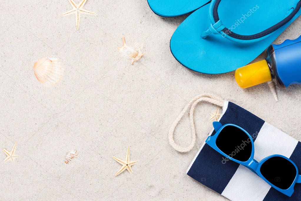 Beach accessory flat lay on sand, summer vacation design