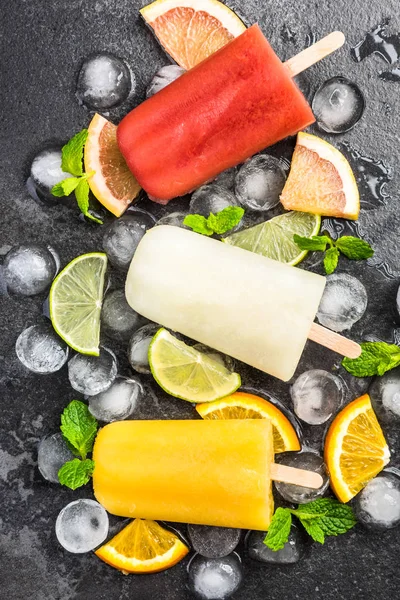 Natural juice homemade healthy popsicles over ice cubes