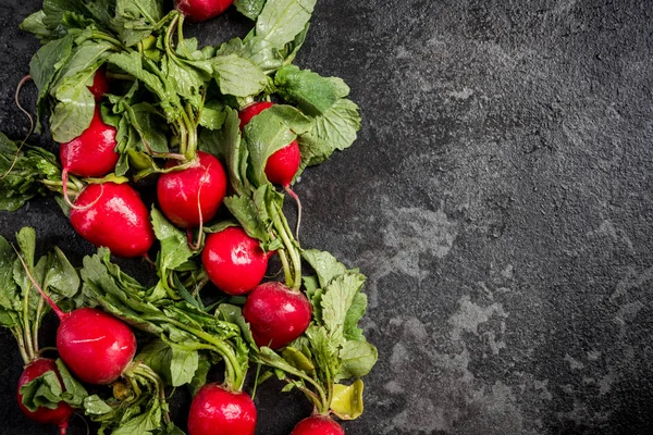 Market fresh organic radish with leaves on dark background — Stock Photo, Image