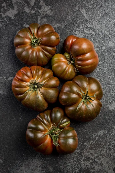 Cały pomidor czekoladowy na ciemnym marmurowym łupku — Zdjęcie stockowe