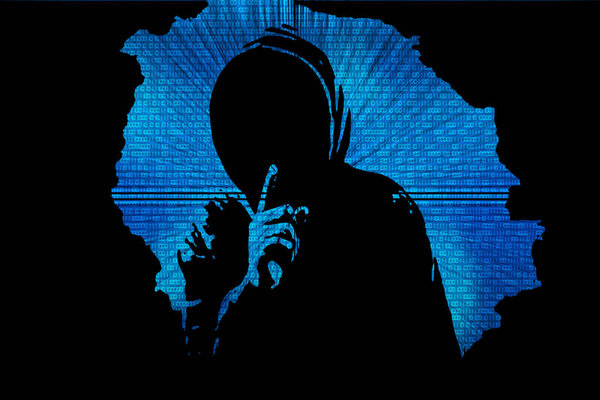Silhouette of a hacker on a background with binary code