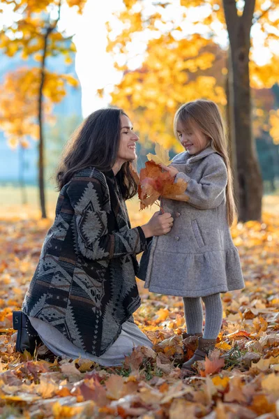 mother and daughter in autumn park