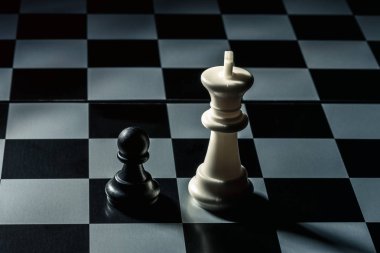 Chess board. White king threatens black opponent's pawn. Horizontal frame clipart