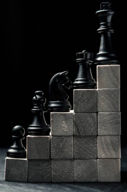 Career ladder. chess from checkers to the king stand on wooden steps. Vertical frame clipart