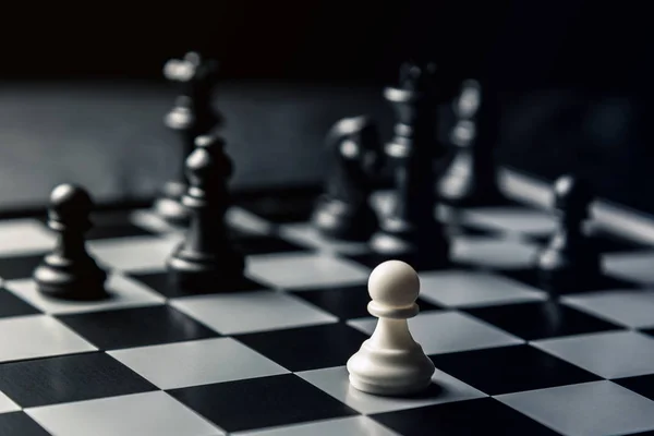 Chess board. White checker threatens the black chess opponent. Horizontal frame