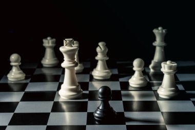 Chess board. Black checker threatens the white chess opponent. Horizontal frame clipart