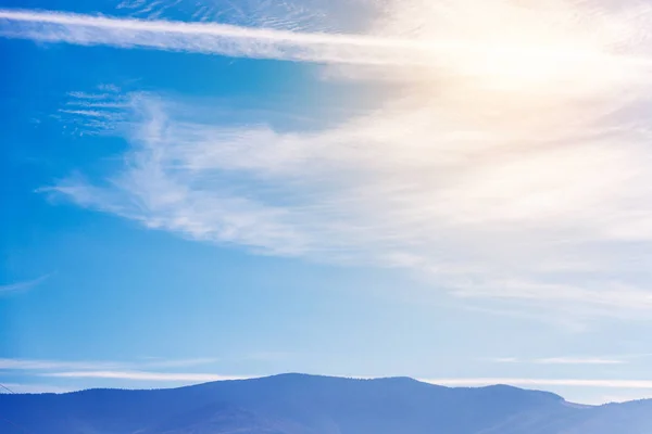 Blue beautiful sky over the mountains. Horizontal frame