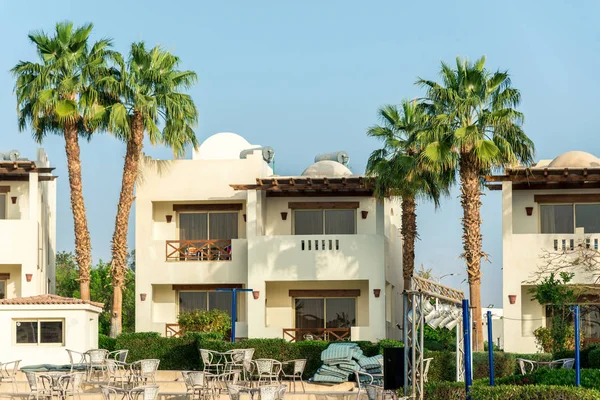 The interior of the hotel, two-story houses among the palm trees