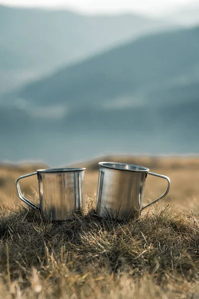 Metal cups on a background of mountains — Stock Photo, Image