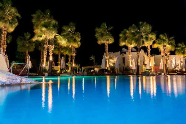 Sharm el-Sheikh, Egypt, 02/25/2019. Night landscape, interior of the hotel overlooking the pool, houses and palm trees