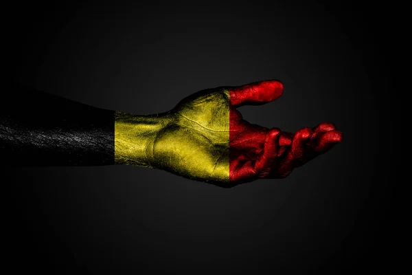 Outstretched hand with a drawn Belgium flag, a sign of help or a request, on a dark background. — Stock Photo, Image