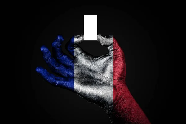 Mano con una bandiera dipinta Francia che tiene un piccolo foglio bianco con spazio per un'iscrizione, finto — Foto Stock