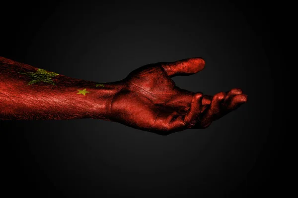 Outstretched hand with a drawn china flag, a sign of help or a request, on a dark background