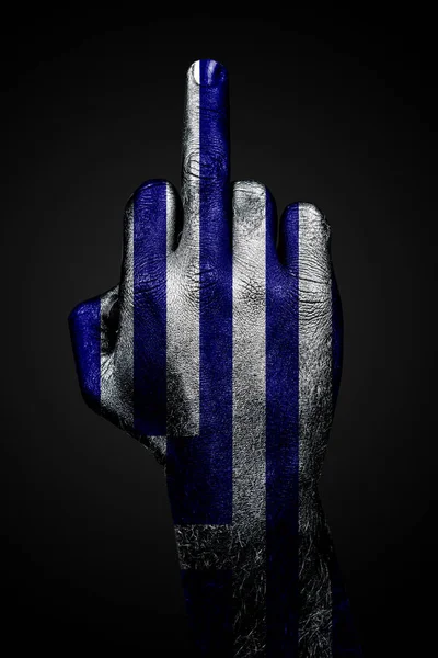 A hand with a painted flag of Greece shows the middle finger, a sign of aggression, against a dark background. — Stock Photo, Image