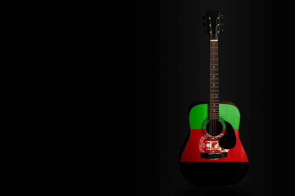 Acoustic concert guitar with a drawn flag Afghanistan, on a dark background, as a symbol of national creativity or folk song. — Stock Photo, Image