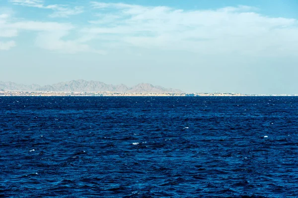 Minimalistic seascape, blue sea and sky with white clouds on the — Stock Photo, Image