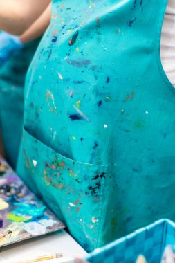 artist's clothes smeared in colorful paints clipart