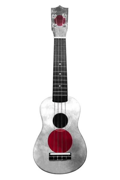 Hawaiianische Nationalgitarre, Ukulele, mit bemalter japanischer Flagge, auf weißem, isoliertem Hintergrund, als Symbol der Volkskunst oder als Nationallied. — Stockfoto