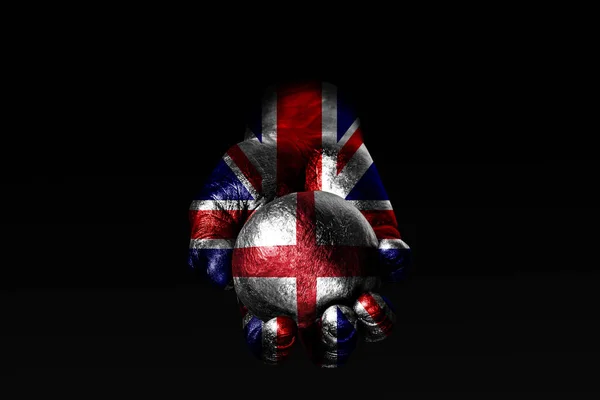 Una mano con una bandera de Gran Bretaña dibujada sostiene una pelota con una bandera de Inglaterra dibujada, un signo de influencia, presión o conservación y protección . —  Fotos de Stock