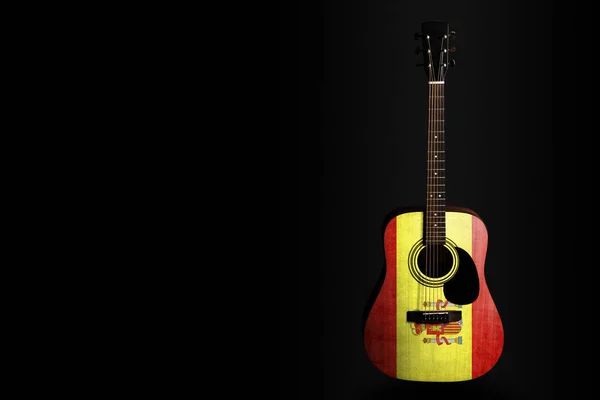 Acoustic concert guitar with a drawn flag Spain, on a dark background, as a symbol of national creativity or folk song. — Stock Photo, Image