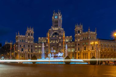 Madrid - Plaza de Cibeles with fountain and figure of Goddess Cibele and their lion driven cart, behind Palacio de Cibeles, post office and seat of the administration clipart