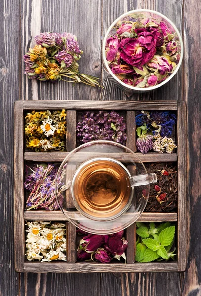 Medicinal and healing herbs. Herbal tea, green tea and black tea in a wooden box, flat lay