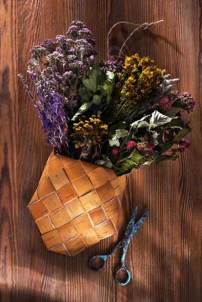 Healing herbs and flowers for herbal tea on a wooden background, top view. Herbal Medicine